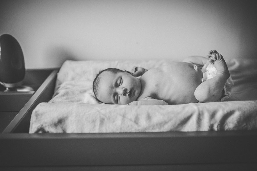 newborn lifestyle shot of baby on change table