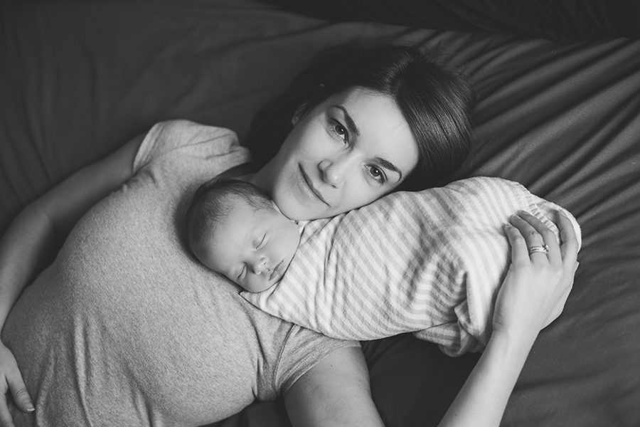 newborn daughter on bed with mom