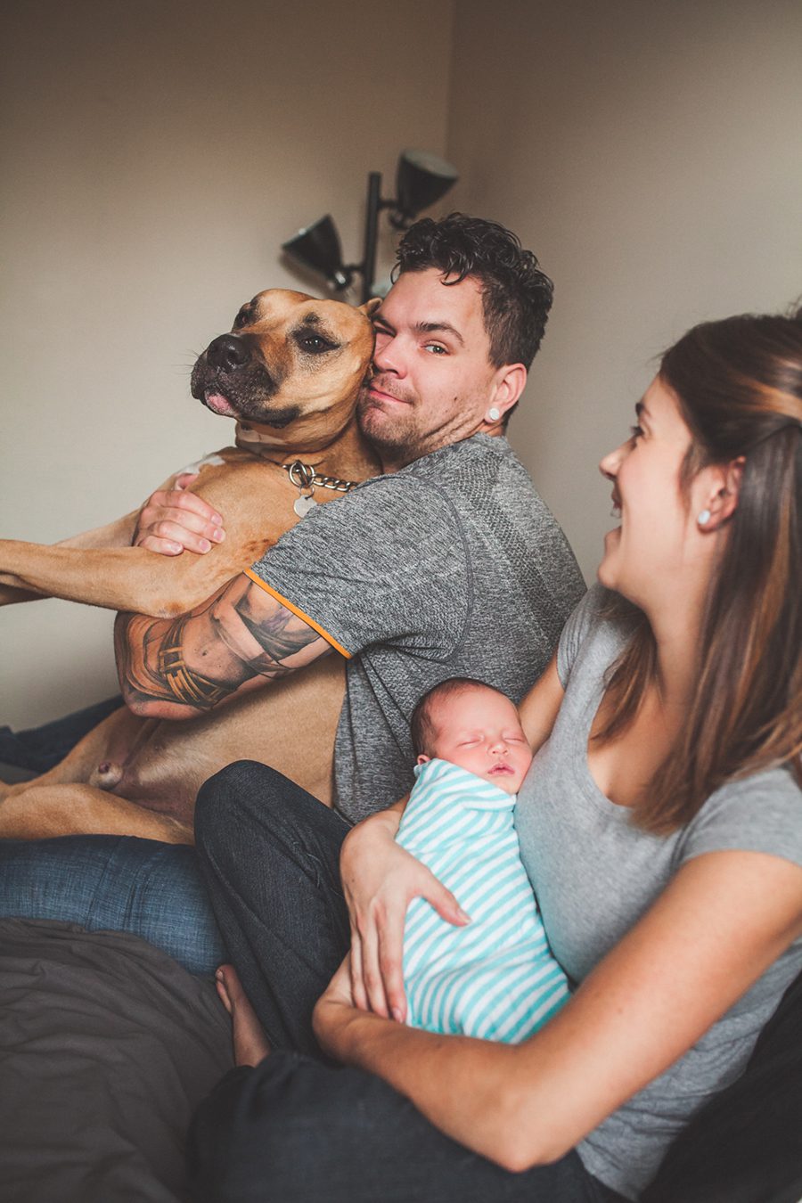newborn family picture dad hugging dog