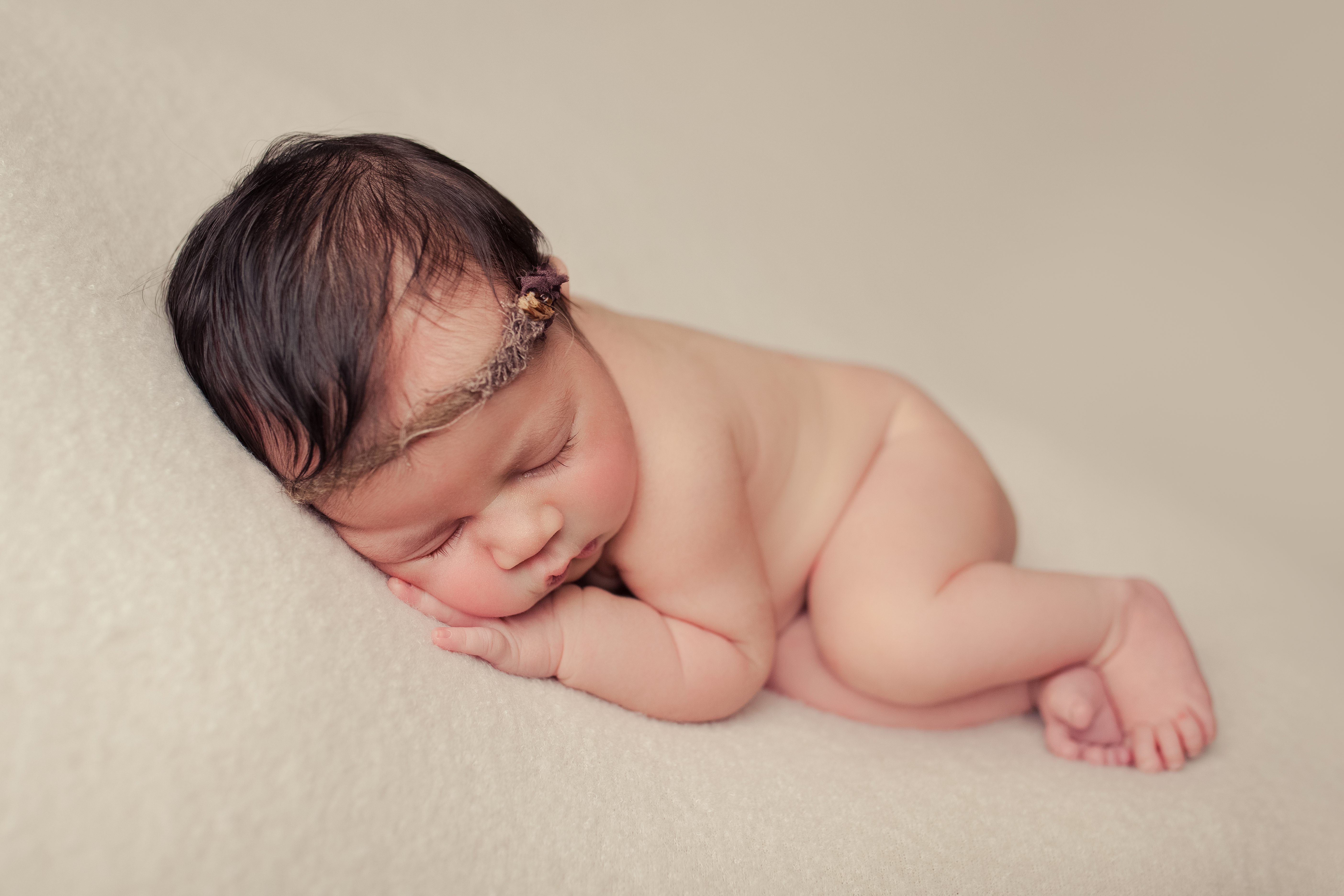 sleepy tummy pose of newborn girl