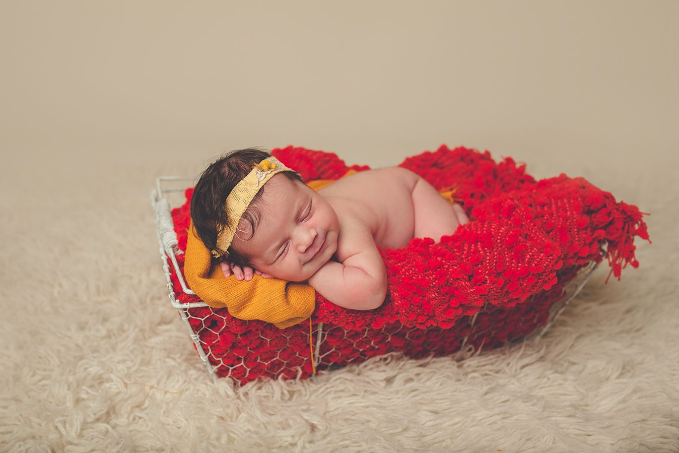 posed newborn photography with mustard yellow