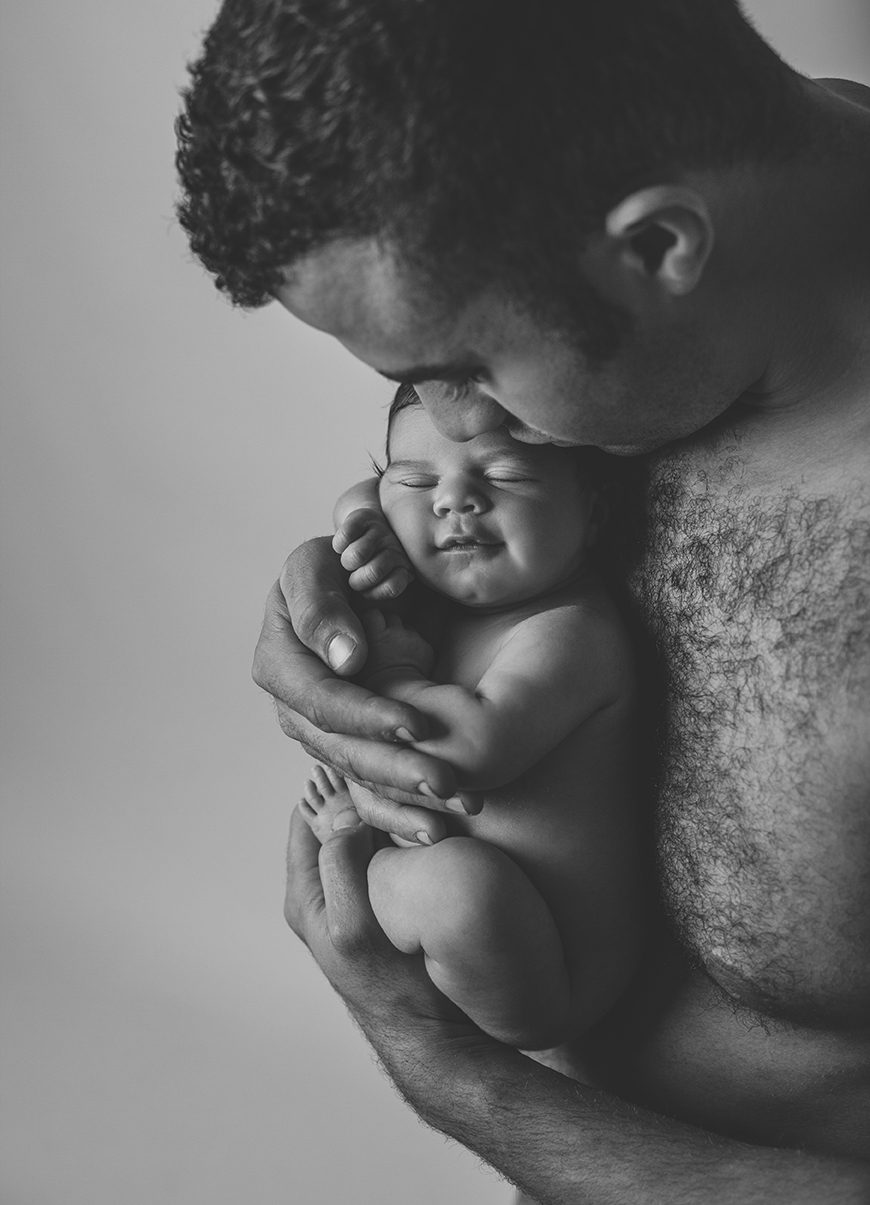 posed newborn photography with newborn baby in dads arms