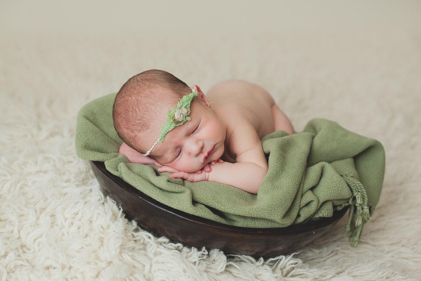 edmonton newborn photographer of baby on green blanket in bowl