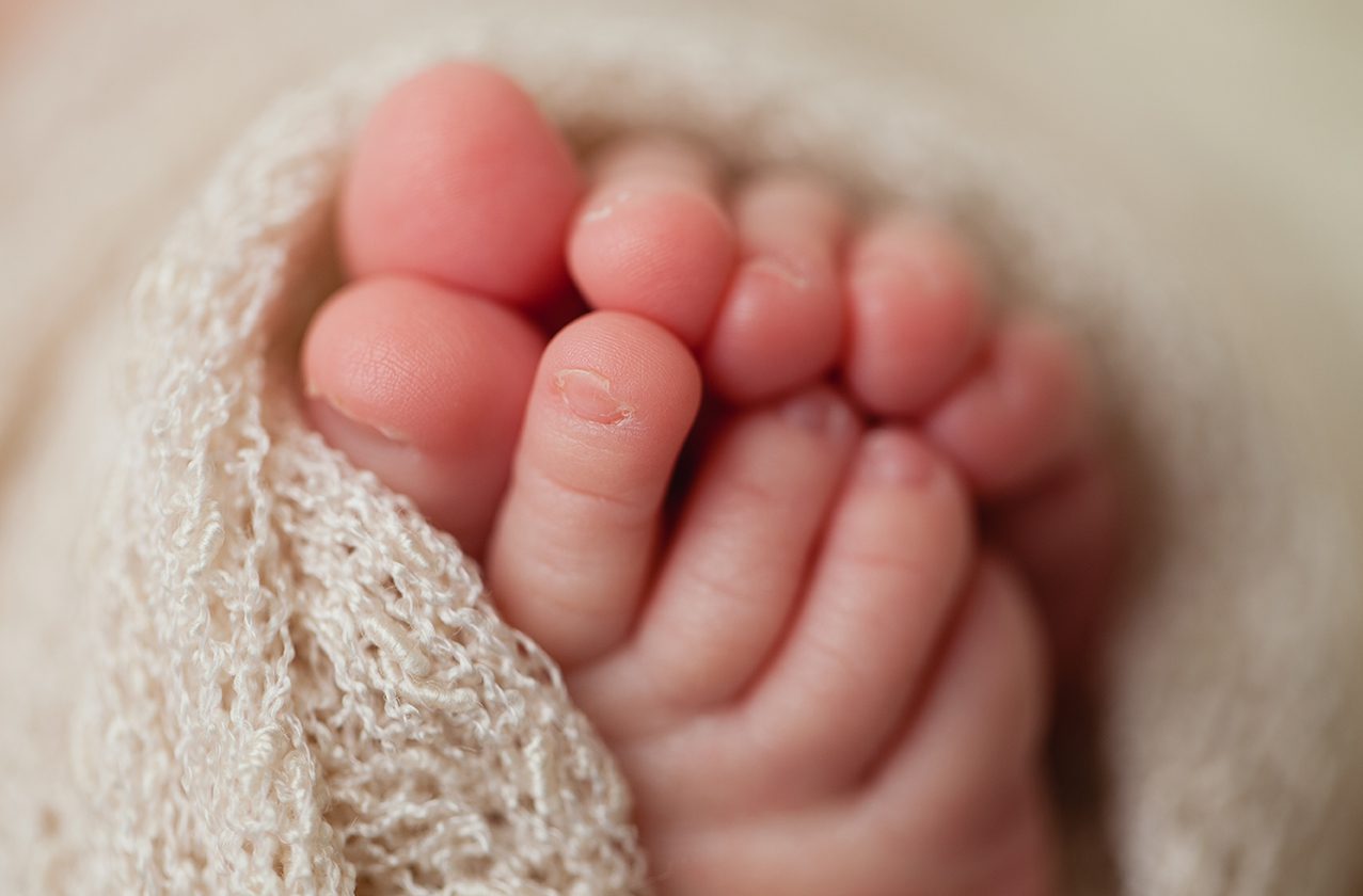 macro shot of feet of newborn girl