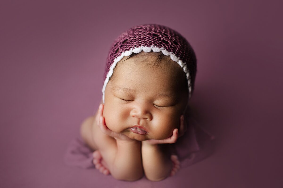 newborn froggy pose, newborn girl photographed on purple fabric, edmonton newborn photographers, edmonton baby photographer