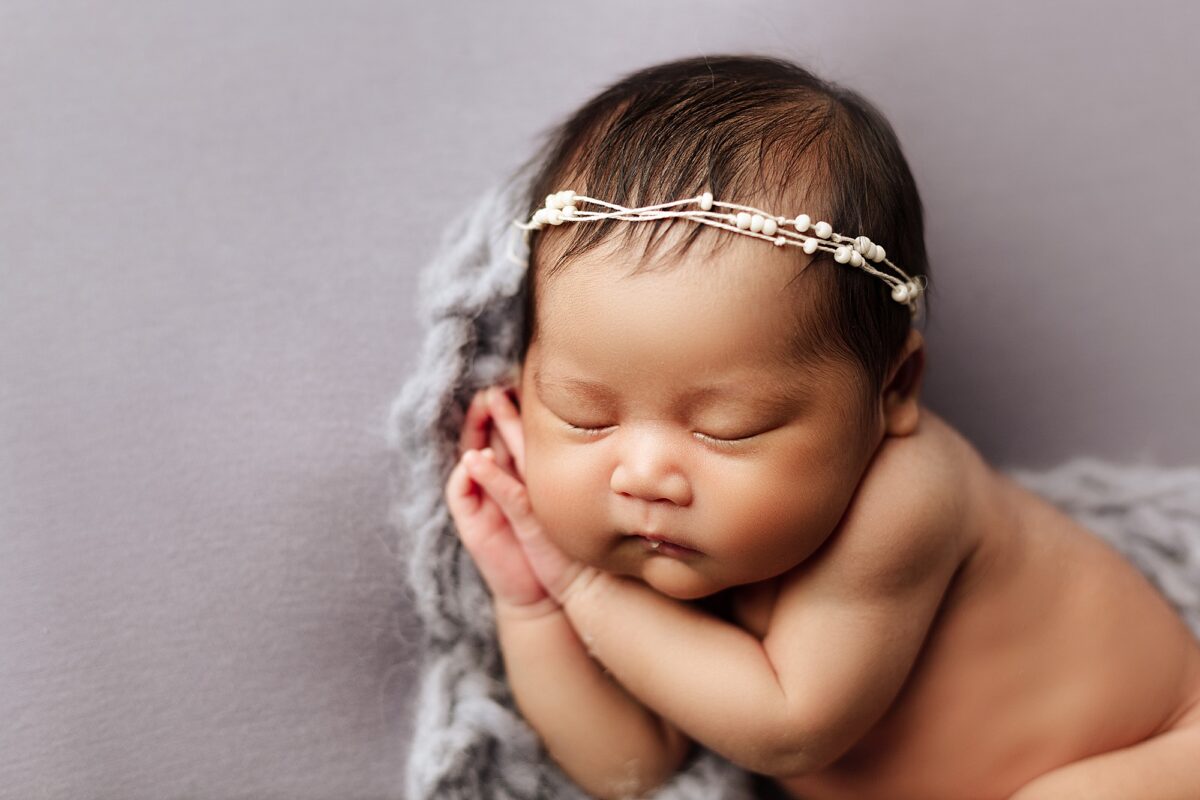 Edmonton newborn photographer, baby newborn girl posed on her hands, newborn baby girl photographed in Edmonton studio