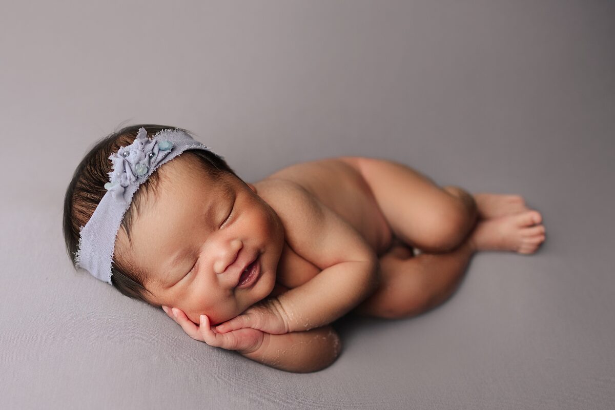 side sleeper pose, newborn photographer edmonton, edmonton newborn photographer, newborn smile