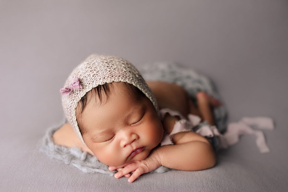 Edmonton newborn photographer, baby newborn girl posed on her hands, newborn baby girl photographed in Edmonton studio