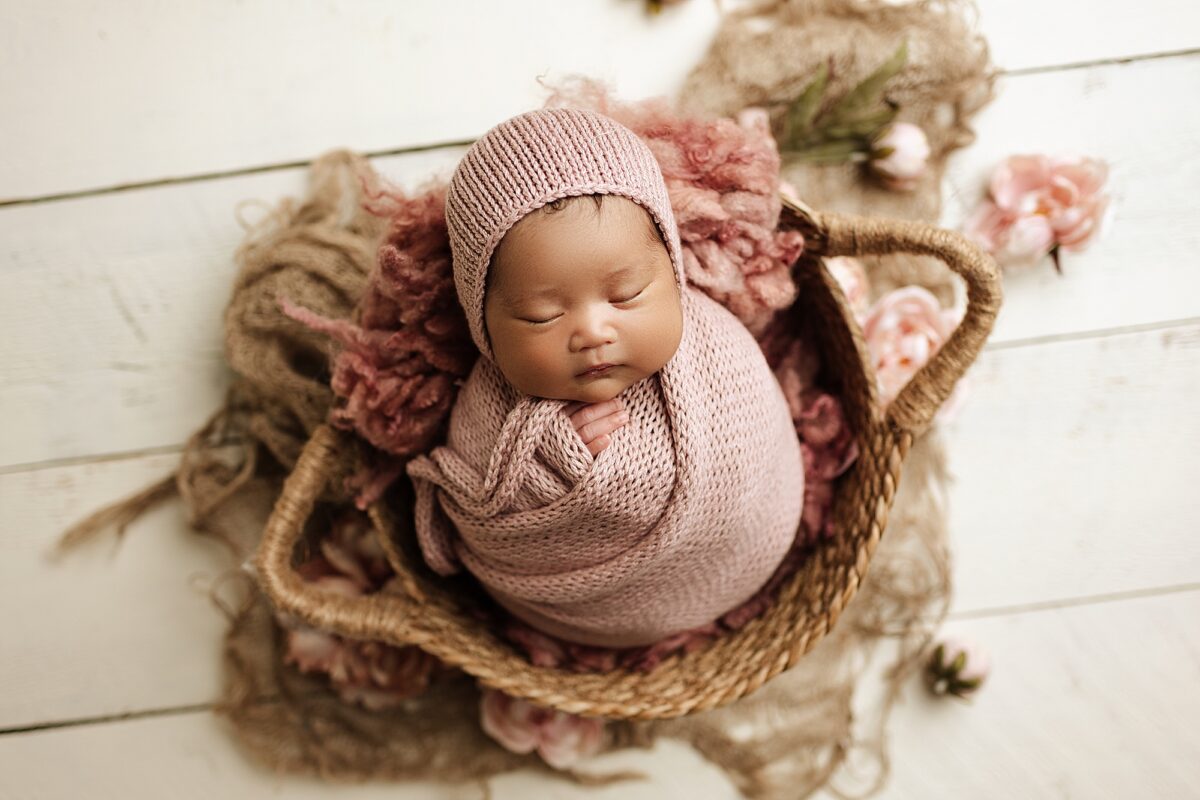 Edmonton newborn photographer, newborn baby girl potato pose in a basket, newborn baby girl photographed in Edmonton studio