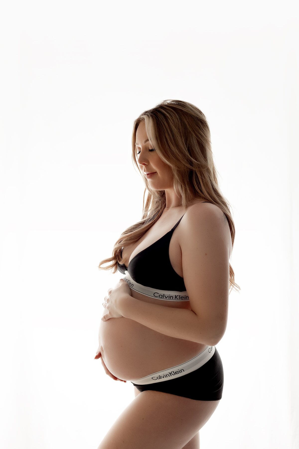 calvin klein maternity, edmonton maternity photographer, edmonton newborn photographer, edmonton maternity photographers, edmonton newborn photographers, high fashion, maternity gown, casual studio maternity, fabric tossing, backlit